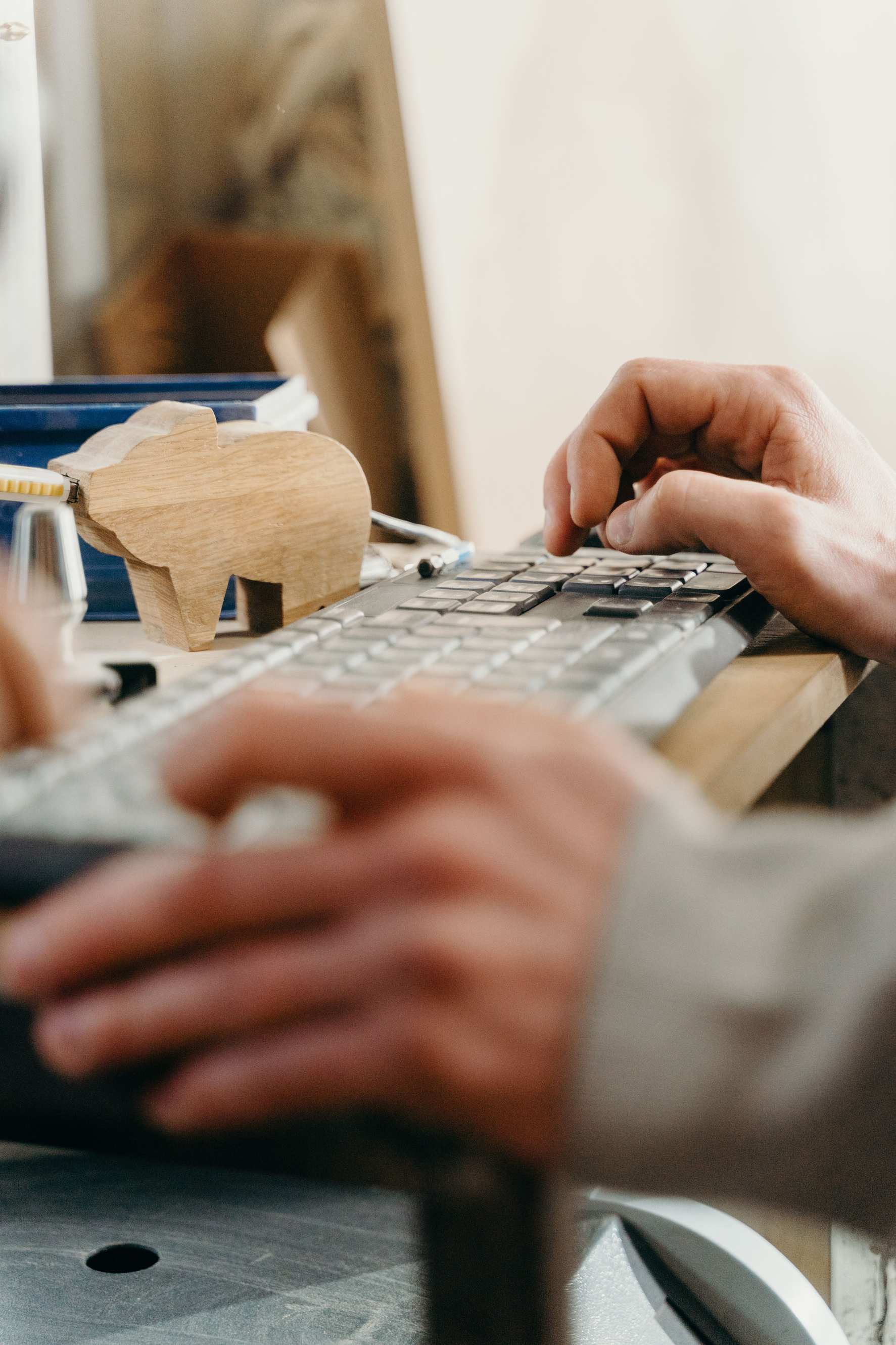 Hands typing on a laptop during a code review session, computer keyboard close-up.